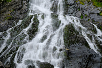 Beautiful waterfall in mountains - Balea Cascada waterfall in Romanian Carpathians, Fagaras Mountains, Romania,