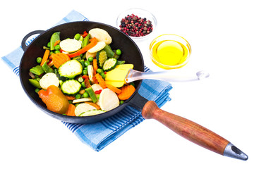 Quickly frozen vegetable mix in frying pan on white background