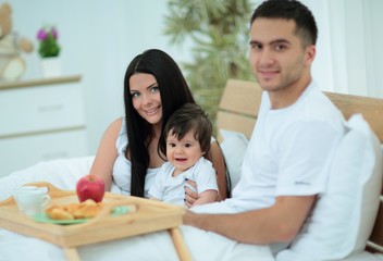 Obraz na płótnie Canvas Family having breakfast in bed at home