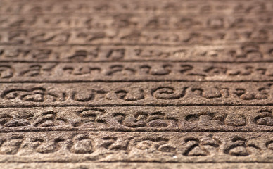Ancient letter with words on Sinhalese language, on wall of 12th century stone temple of Polonnaruwa, Sri Lanka