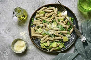Whole wheat pasta penne with zucchini and green pea.Top view.
