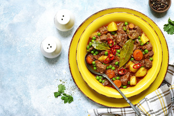 Slow cooker beef ragout with vegetable ( potato, sweet pea and carrot ) . Top view with copy space.