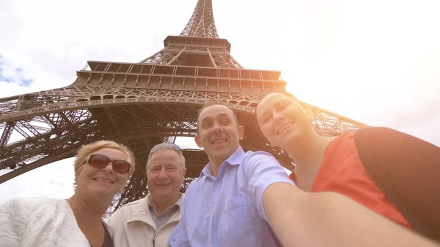  Professional video of happy family making selfie under the Eiffel tower in Paris in 4k slow motion 60fps