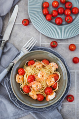 Spaghetti with prawns and cherry tomatoes, top view