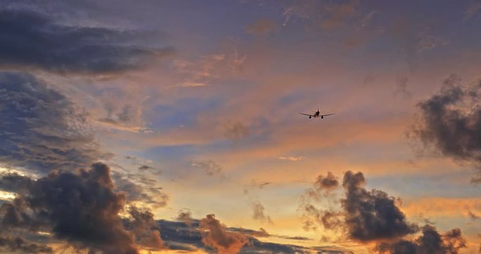 Conceptual traveling background of airplane flying away into majestic sunset sky to new destination