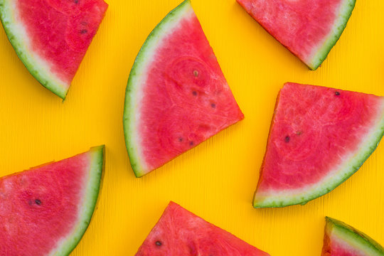    Fresh watermelon slices on the yellow background. Summer fruit concept. 

