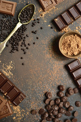 Ingredients for making chocolate cake or candy : chocolate chips, bar and spices.Top view with copy...