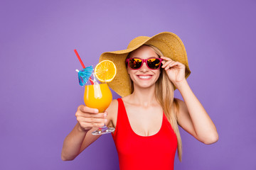 Party mood and beach style isolated on bright purple background! Blonde girl in red swimsuit laughs...