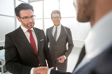 Manager shaking the hand of the customer