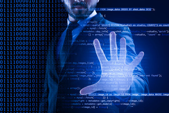 Businessman working with virtual screen on dark background