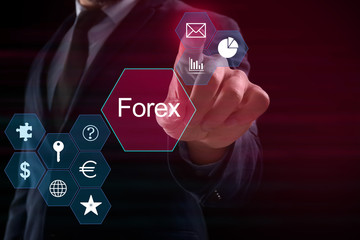 Businessman pushing button on virtual screen against dark background