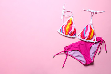 Naklejka premium Stylish bikini on color background, top view