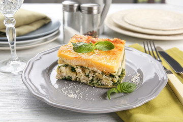 Lasagna with spinach served on table