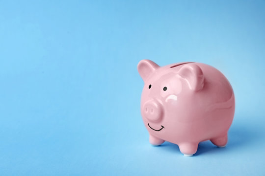 Pink piggy bank on color background. Money saving