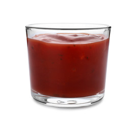 Glass of spicy chili sauce on white background