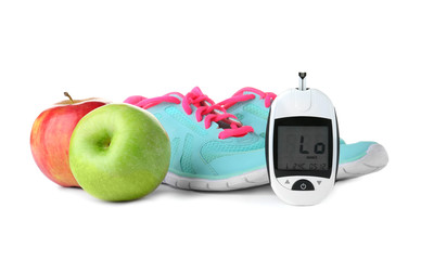 Digital glucometer, apples and sneakers on white background. Diabetes concept