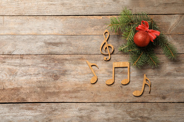 Flat lay composition with decorations and  notes on wooden background. Christmas music concept