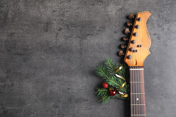 Guitar and decorations on gray background. Christmas music concept