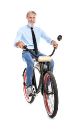 Obraz na płótnie Canvas Portrait of handsome mature man with bicycle on white background