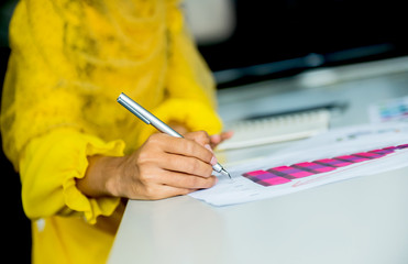 Muslim businesswomen writing and sign on the paper.