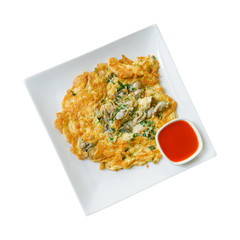 homemade oyster omelets with chili sauce on white plate isolated white background with clipping path