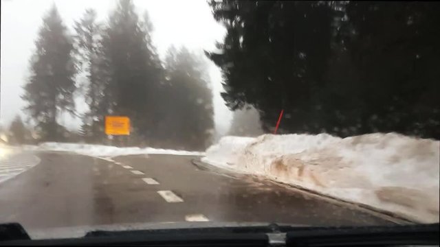 Driving through the black forest, schwarzwald, in Seebach, Germany while it is cold, foggy, misty, and with lots of snow on the ground.