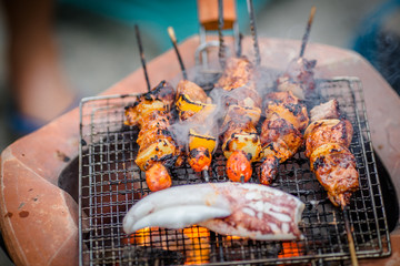 Barbecue skewers meat kebabs with vegetables on flaming grill