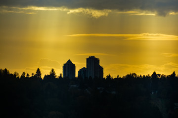 Residential towers silhouette on sunset sky background