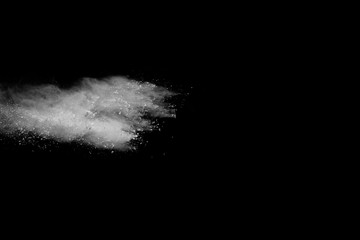 Fototapeta na wymiar Launched white powder, isolated on black background.