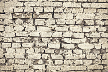 Brick wall of rough masonry coated with lime, textured background