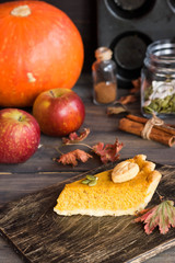 Traditional homemade American pumpkin pie with a decor of a cookie in the form of leaves for a holiday