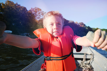 Boy rowing a boat on a lake