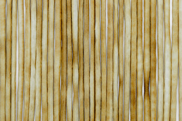 Group of baked italian bread sticks background on white background surface