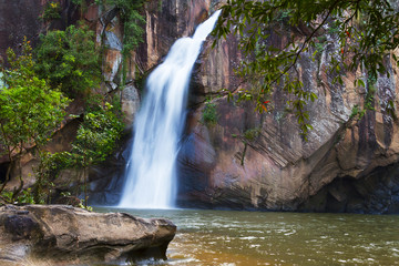 Fototapeta na wymiar Waterfall beautiful with forest and stone