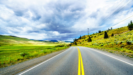Dark Clouds hanging over the fertile farmland and rolling hills along Highway 5A near Nicola Lake,...