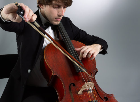 Portrait of the cellist on a light background.