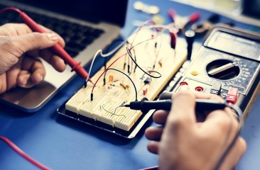 Closeup of multimeter measuring breadboard