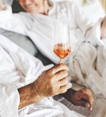 Couple having prosecco in bed
