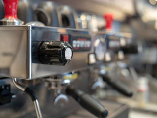 Fototapeta na wymiar Close view of large, stainless steel industrial expresso machine in a coffee shop