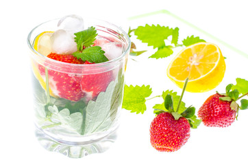 Cold summer drink with strawberries, lemon and mint