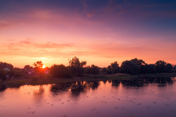 Fototapeta na wymiar Magical purple sunrise over lake. Misty morning, rural landscape, wilderness