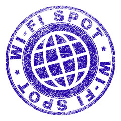 WI-FI SPOT stamp imprint with distress effect. Blue vector rubber seal imprint of WI-FI SPOT title with dust texture. Seal has words arranged by circle and globe symbol.