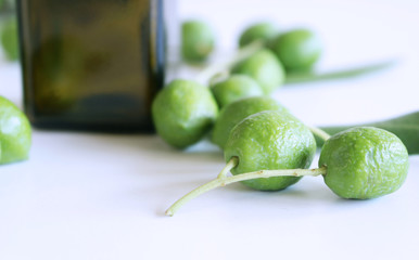Fresh green olives isolated on white background close up.Blurred background.