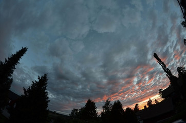 Astronomical summer in Scandinavia. Midnight sky during the solstice. Typical town in Norway
