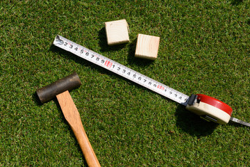 tools(hammer, wood, measure) on turf