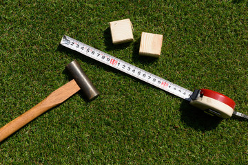 tools(hammer, wood, measure) on turf