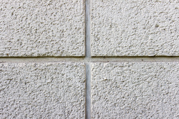 Texture of concrete wall with a cross in the center of image. Plaster texture with small holes.