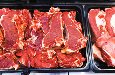 Large piece of red fresh meat on the counter. 