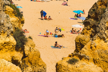 Happy family vacation at Paradise. People relaxing on the yellow sand of beach. Happy sea lifestyle. Young family, man and woman rest on the beach of ocean. Love travel