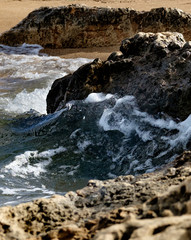 Powerful Waves on a rocky beach. Splits waves against rocks in the sea